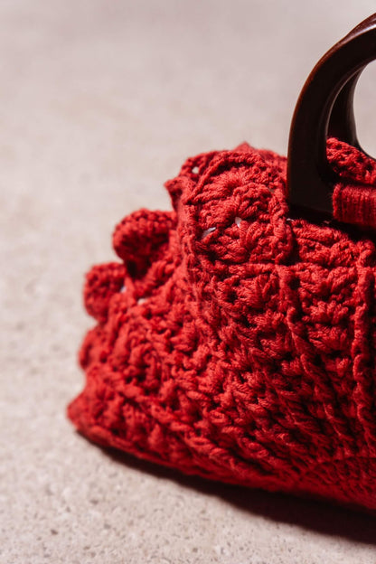 Detalle de textura en crochet del bolso artesanal Cabori Buganvilla en color granate con asas de madera.